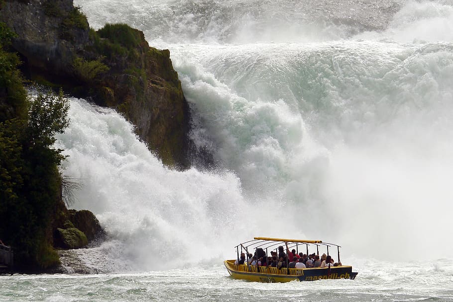 group of people inside boat on body of water, rhine falls, schaffhausen