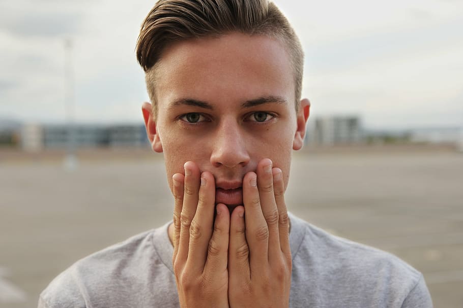 man wearing gray crew-neck shirt touching his face, model, person HD wallpaper