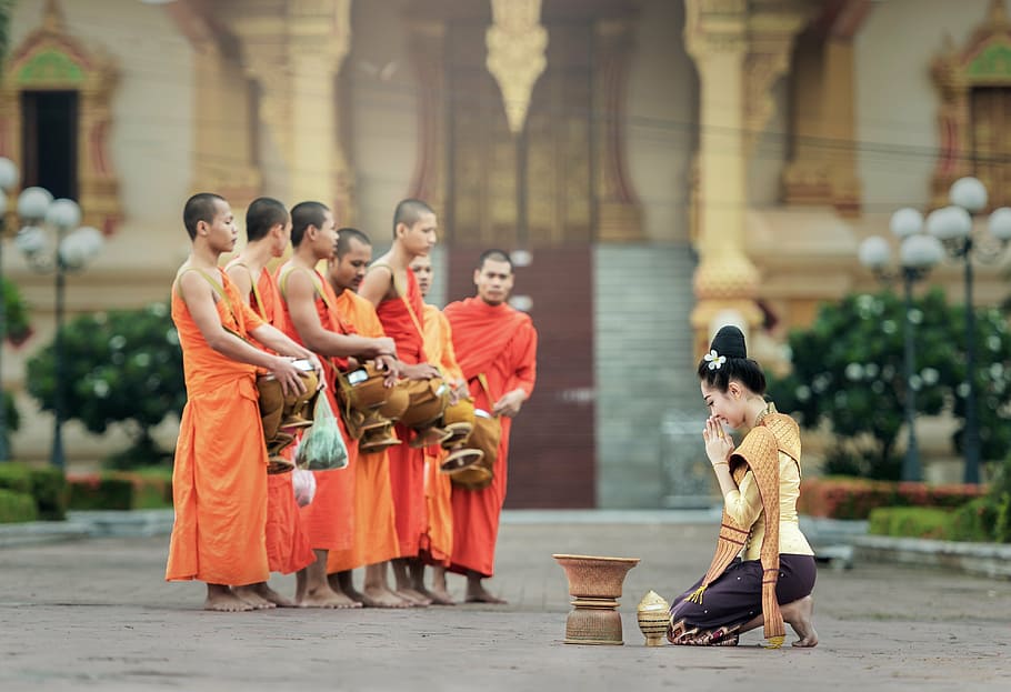 woman kneeling in front of brass-colored container, monks, i pray