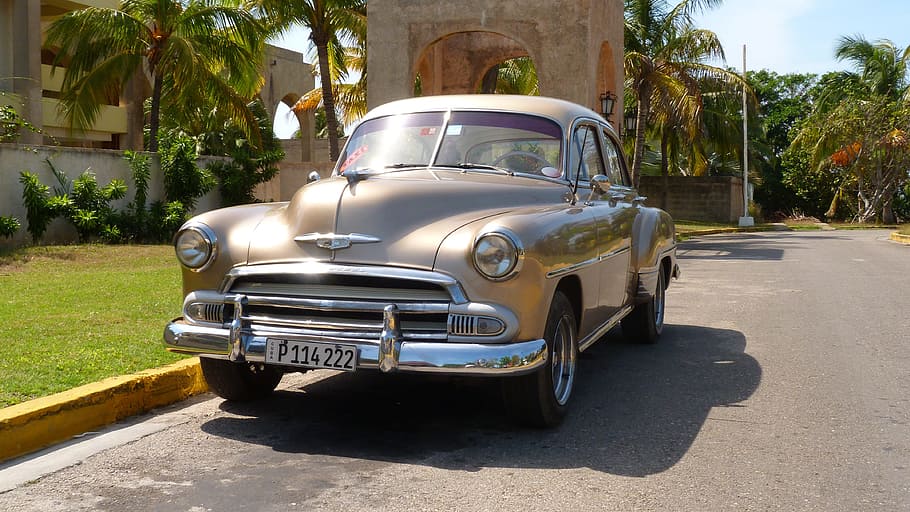 classic beige sedan parked near yellow concrete gutter at daytime HD wallpaper