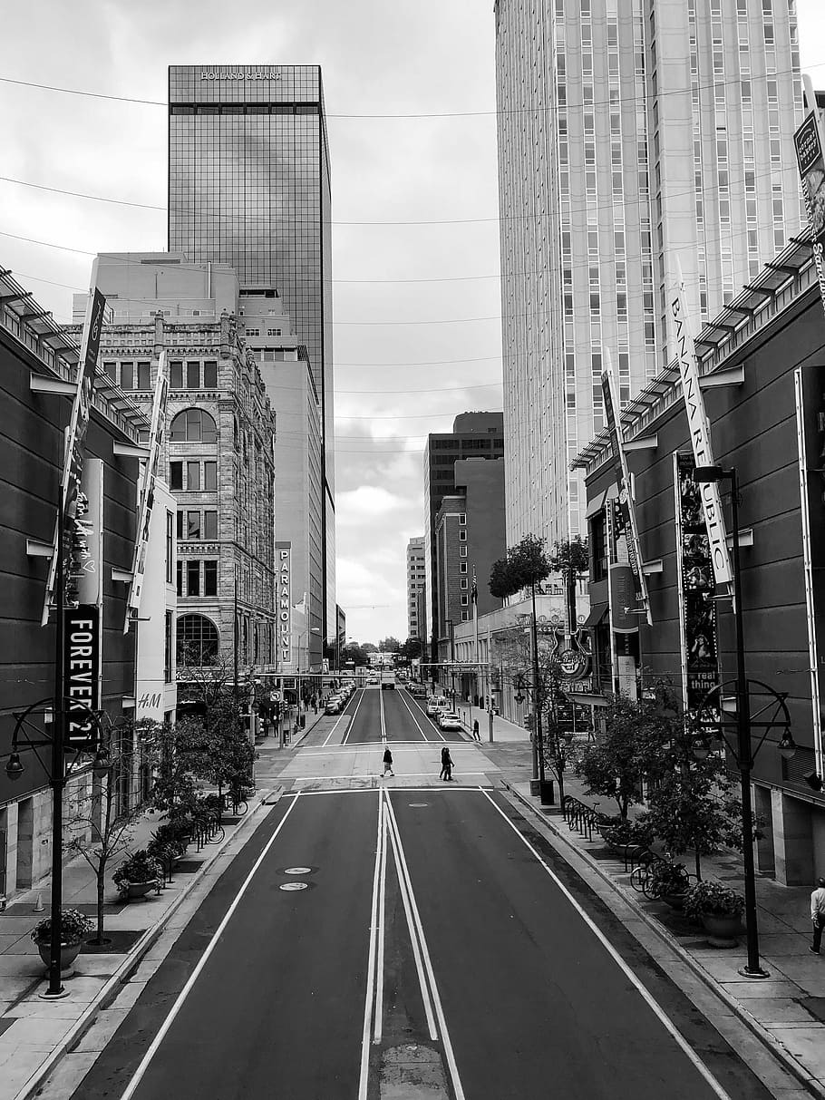 grayscale photo of high-rise buildings near road, people walking across road HD wallpaper