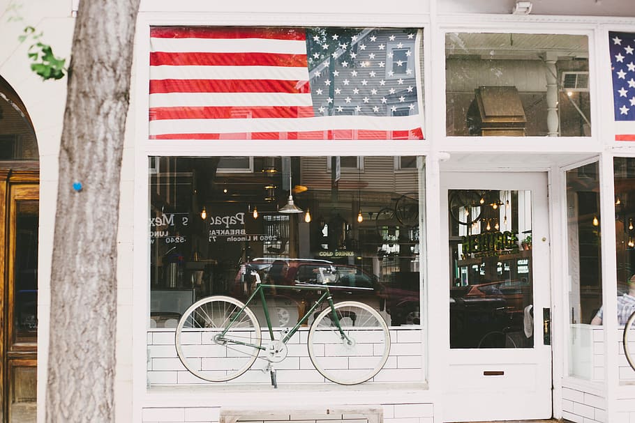 flag of America, green commuter bike on top of white wooden board infront of clear glass wall HD wallpaper