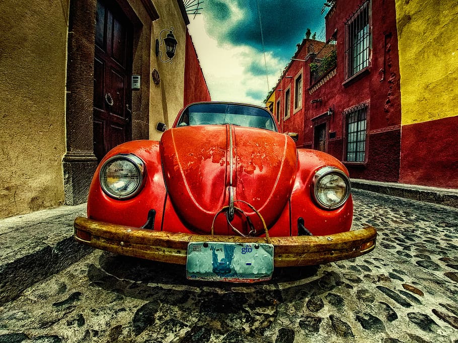 red Volkswagen Beetle coupe parked at the road near buildings, HD wallpaper