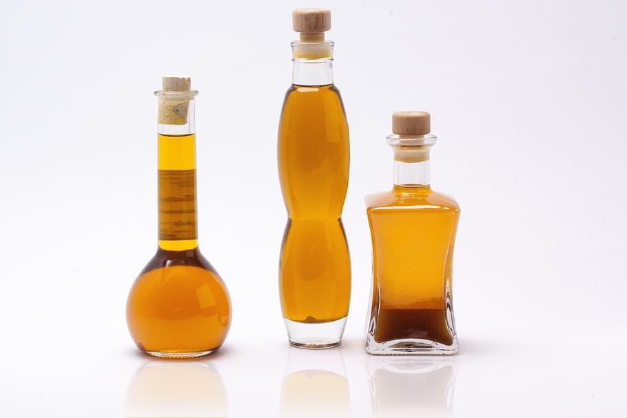 three olive oils on clear glass bottles, cosmetics, breed perl oil
