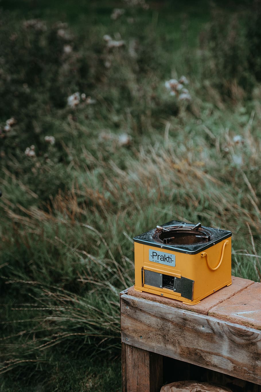 Prakti Charcoal Burning Stove, selective focus photography of yellow burner stove on brown panel HD wallpaper