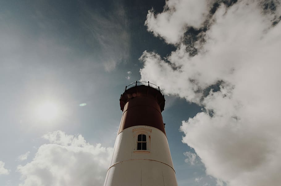 high-angle photography of white and black lighthouse tower during day time, low angle of white and red painted lighthouse HD wallpaper