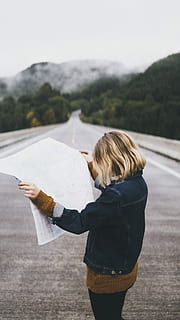 woman looking at map while standing on road, woman reading newspaper at the road HD wallpaper