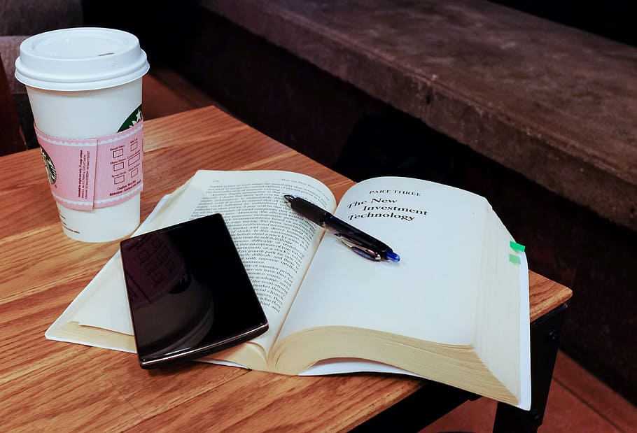 open book and black smartphone, mobile, technology, reading, starbucks, HD wallpaper