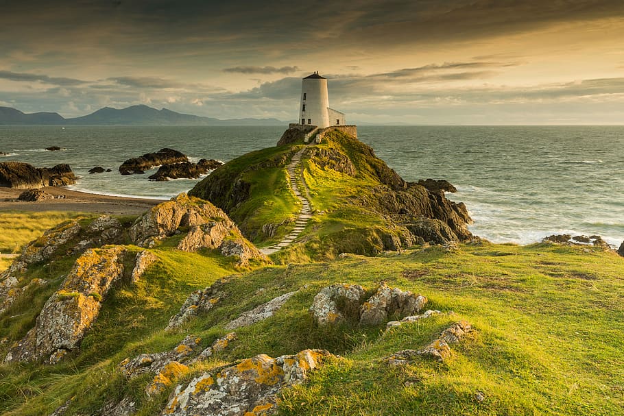 white concrete lighthouse on cliff beside sea under clear blue sky during daytime, light tower on mountain HD wallpaper