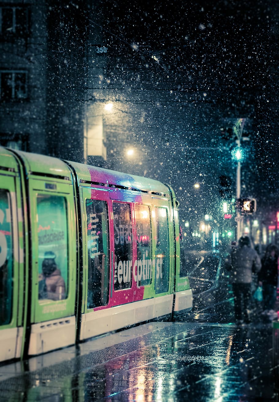 green and red train, person beside the train during snow time HD wallpaper
