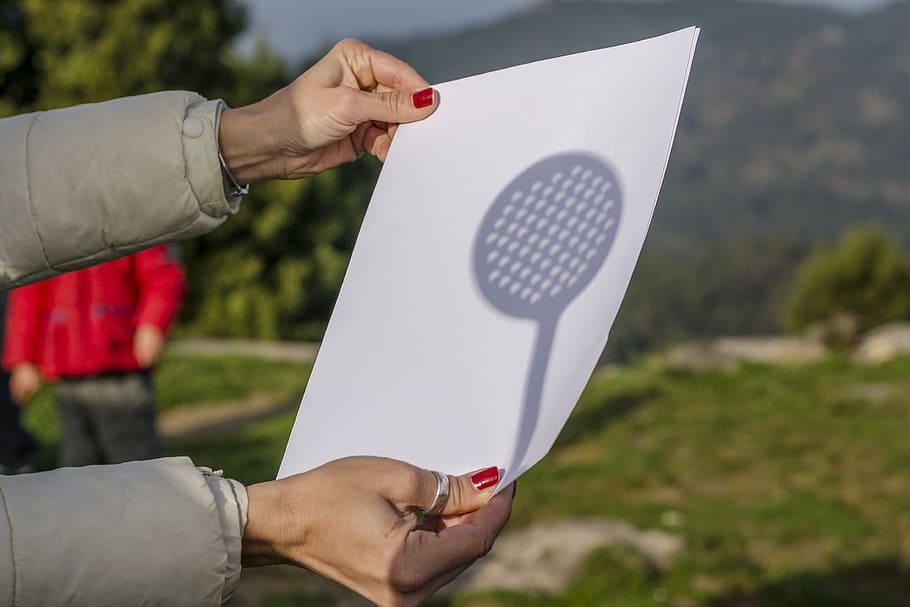 person holding white printer paper, sun, eclipse, shadow, sunny day HD wallpaper