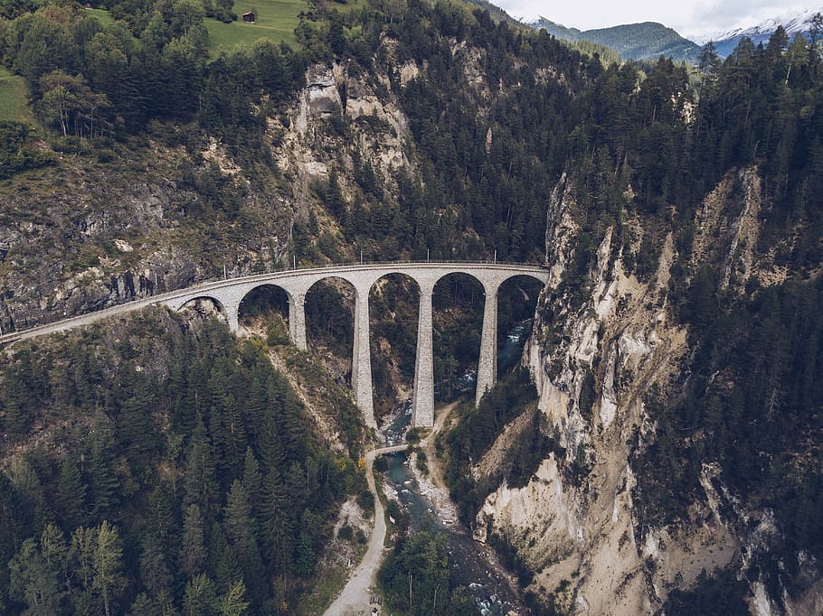 aerial view of bridge between mountains, aerial photo of gray concrete bridge HD wallpaper