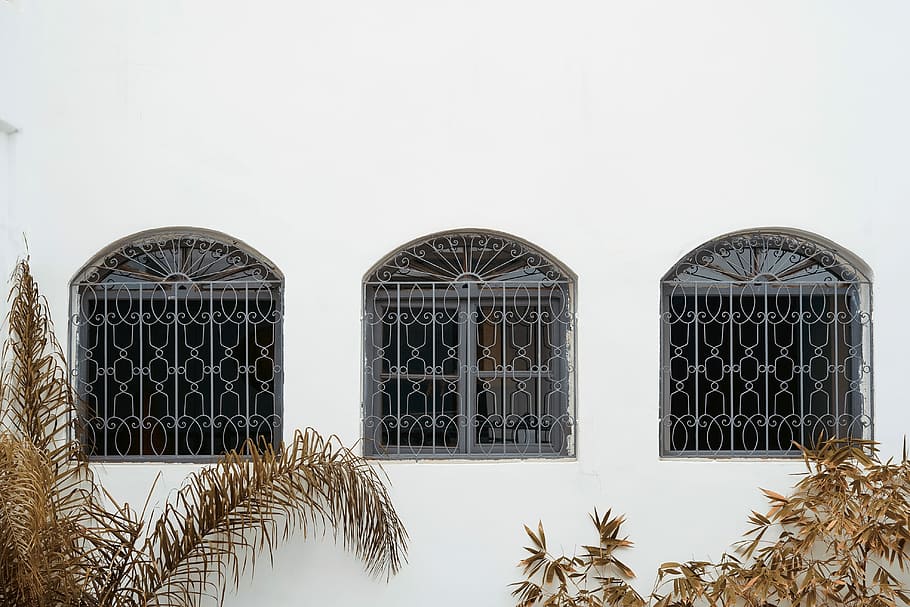 white painted building, three gray metal window frames, minimal