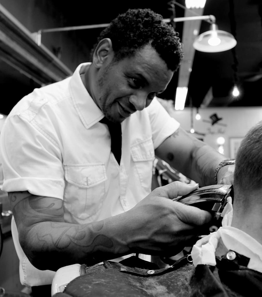 grayscale photo of man holding black hair trimmer, barber, haircut
