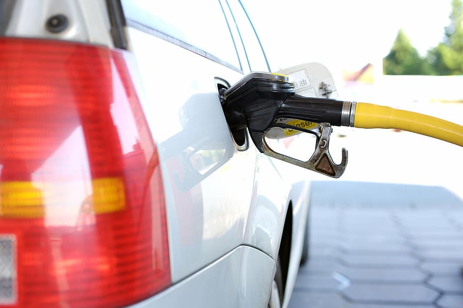 white vehicle filling gas tank using gasoline pump, refuel, petrol stations