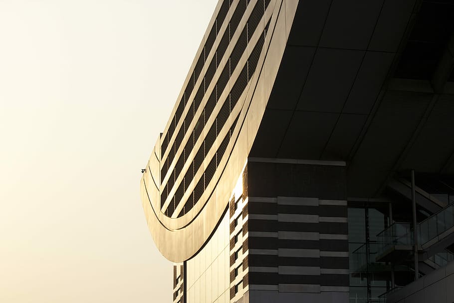 The facade and roof of a modern building in bright sunlight, low-angle of high-rise building HD wallpaper