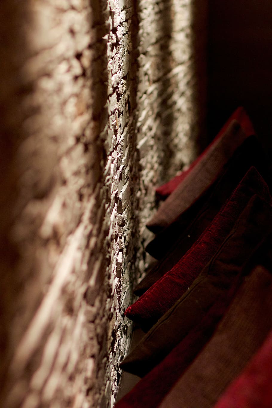 stone wall, pillow, shadow, light, ambience, selective focus HD wallpaper