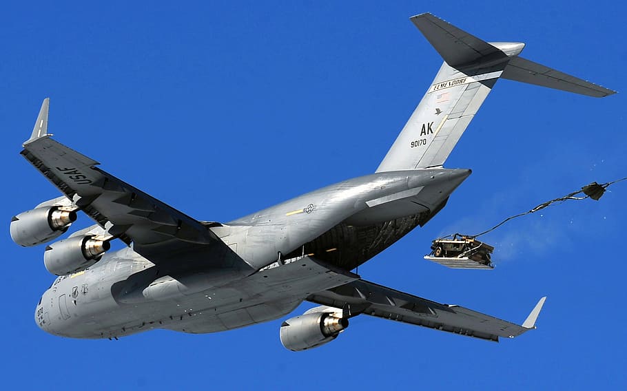 gray aircraft dropping truck, cargo jet, c-17, airdrop, humvee