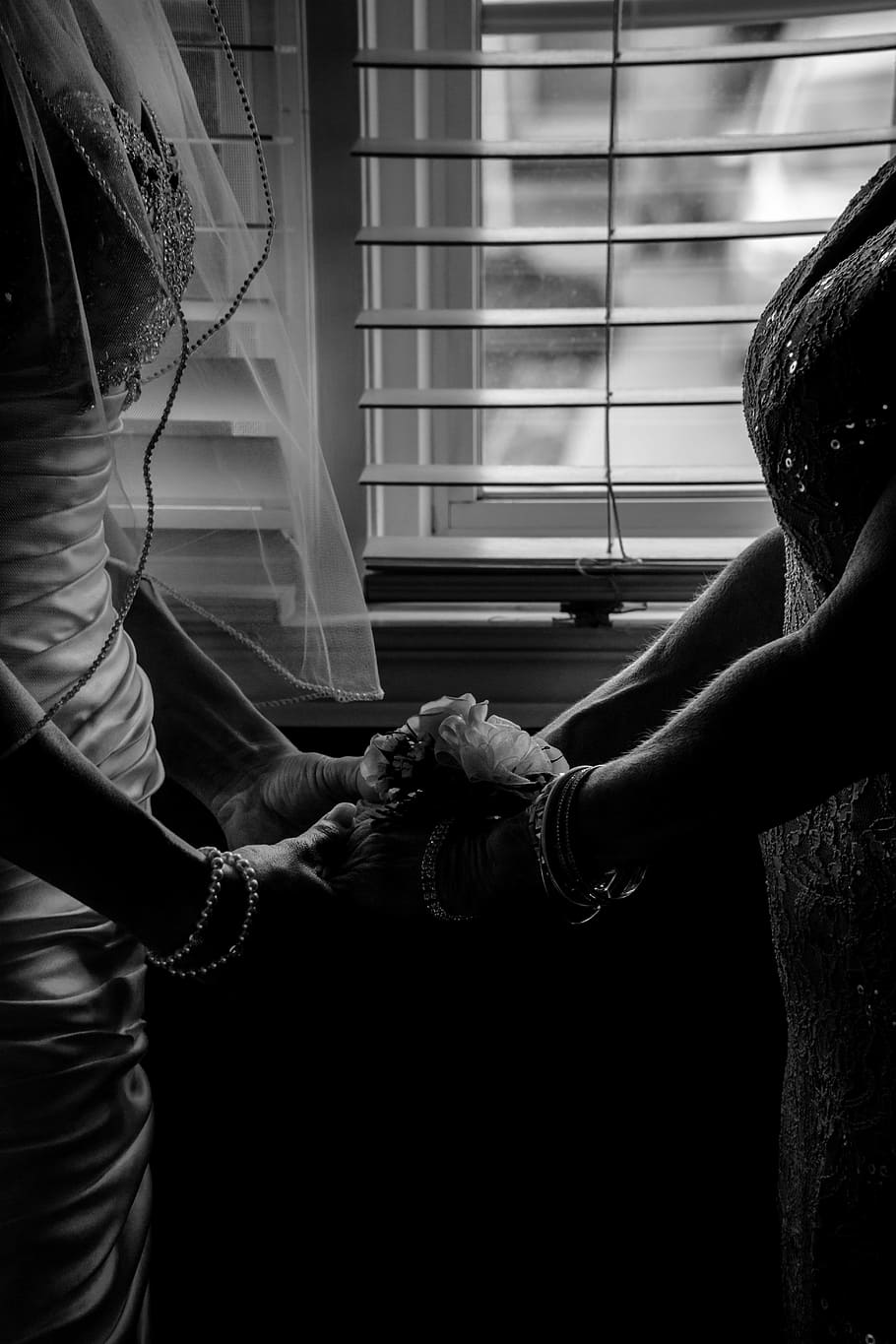 grayscale photography of two woman holding hands near window blinds, grayscale photography of woman wearing wedding gown holding the hands of woman HD wallpaper