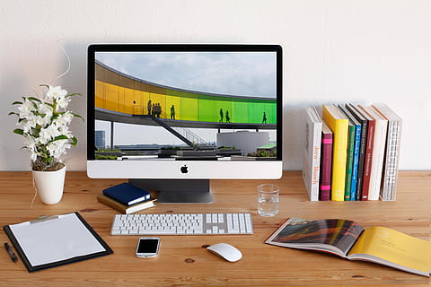 turned-on iMac beside books on desk, workplace, desktop, creative HD wallpaper