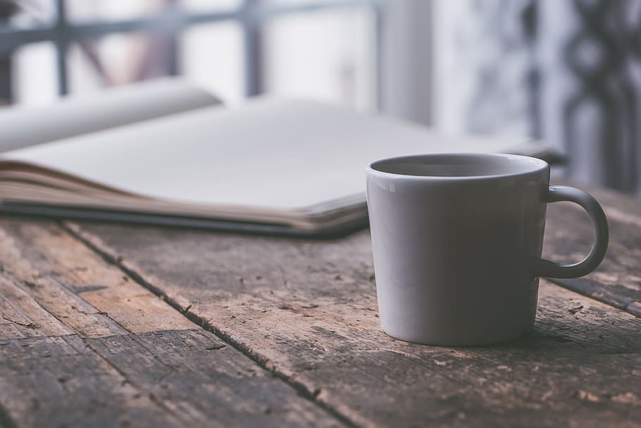white ceramic mug on table, background, black coffee, business