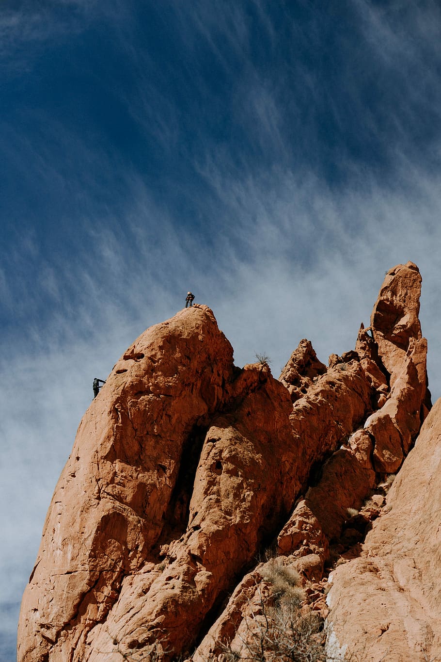 two person on rocky hill during daytime, two person climbing on large rock during daytime HD wallpaper