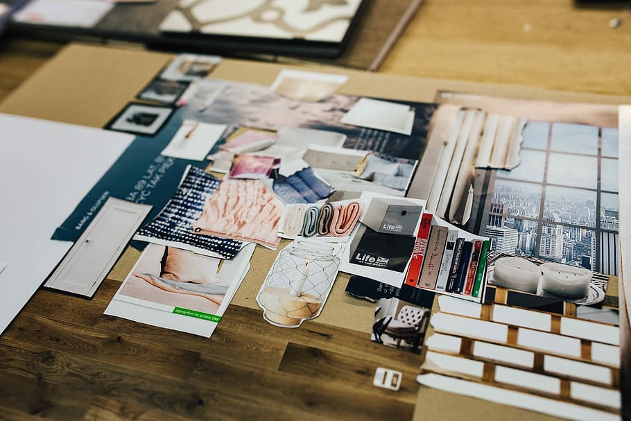Designers working with material samples and paper cutouts, fabric HD wallpaper