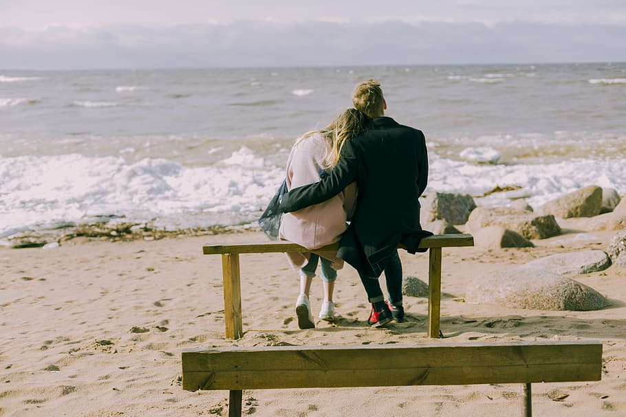 Man and Woman Hugging and Sitting on a Bench, beach, couple, daylight HD wallpaper