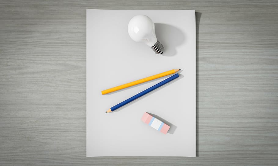 two yellow and blue pencils between LED bulb and eraser on white surface HD wallpaper