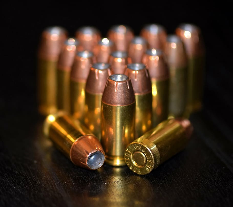 shallow focus photo of gold ammunition, bullets, ammo, brass