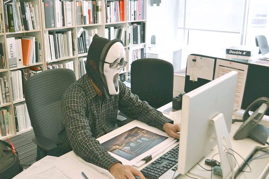 person wearing ghost mask while using computer desktop, keyboard HD wallpaper