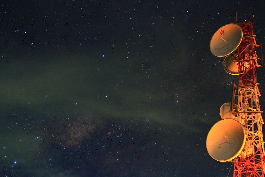 astrophotography red and white tower with satellites under milky way, white and orange signal tower during nighttime HD wallpaper