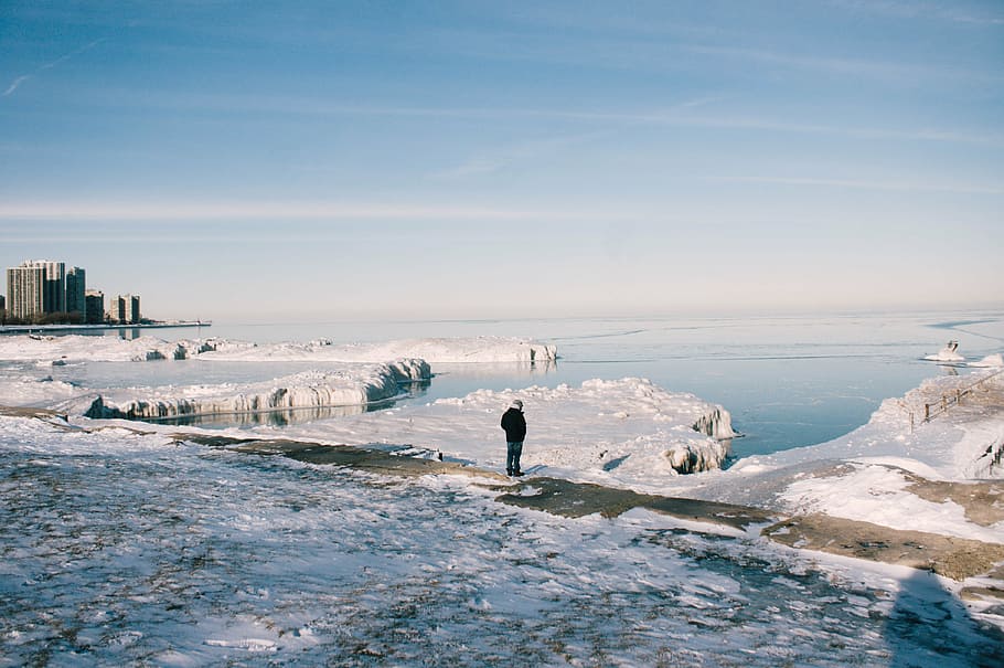 man standing on ground covered with snow during daytime, black HD wallpaper