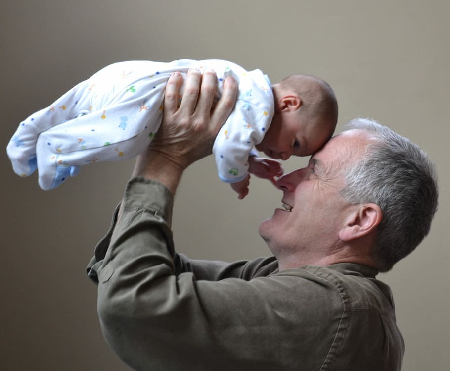man lifting baby up, grandfather, grandpa, love, mystery, together