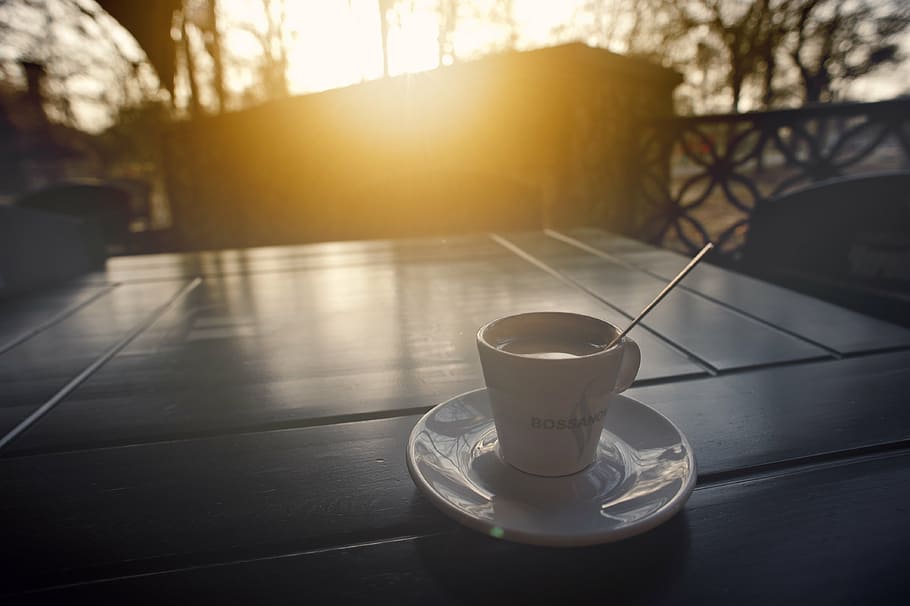 full-filled white ceramic cup, coffee, saucer, table, sunset HD wallpaper