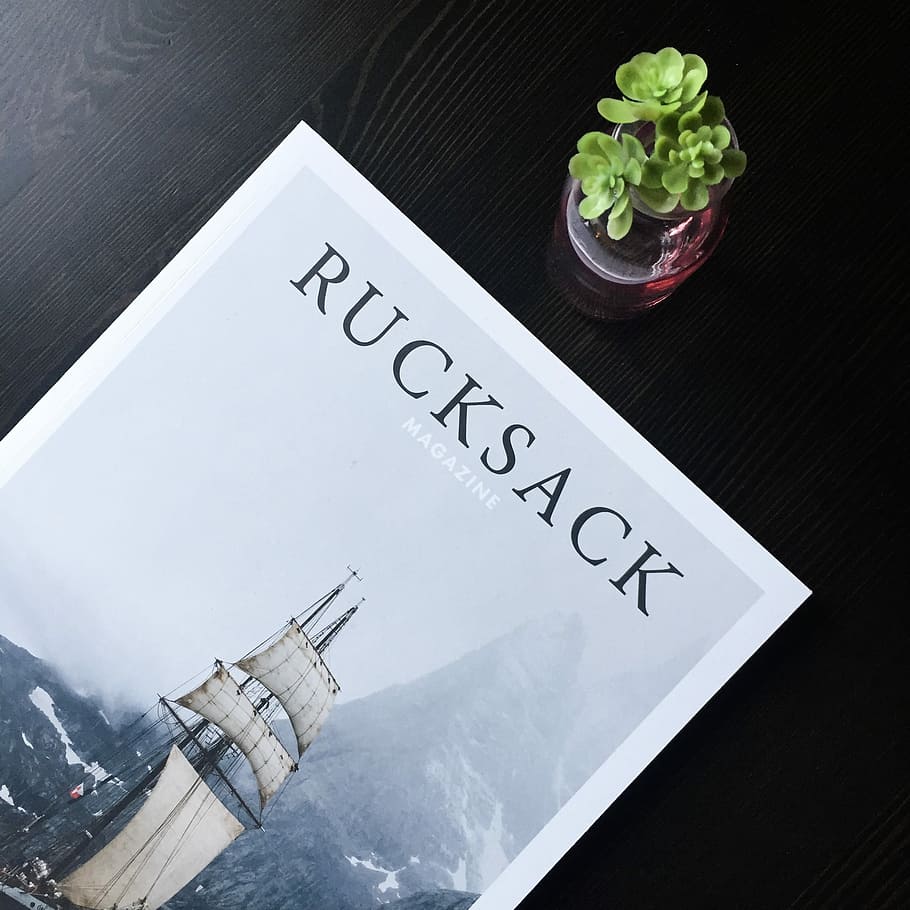 Rucksack magazine, Rucksack magazine on table, typography, plant HD wallpaper
