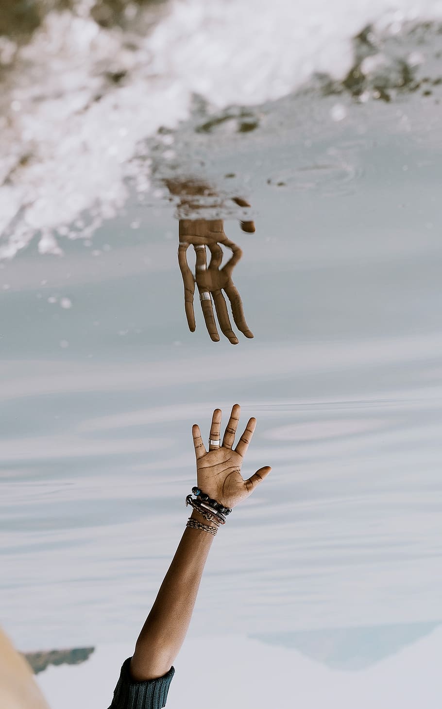 person's hand reaching on water with reflection ], person reaching body of water with his hand reflection photography HD wallpaper