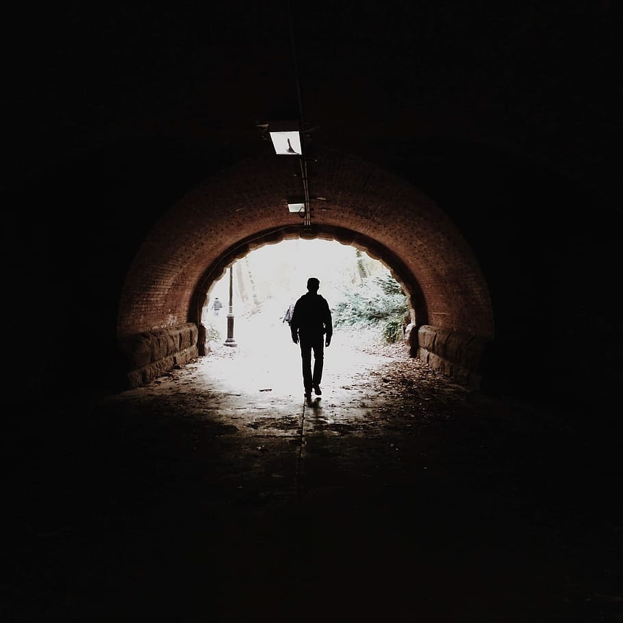 man walking in tunnel, guy, dark, silhouette, people, shadow HD wallpaper