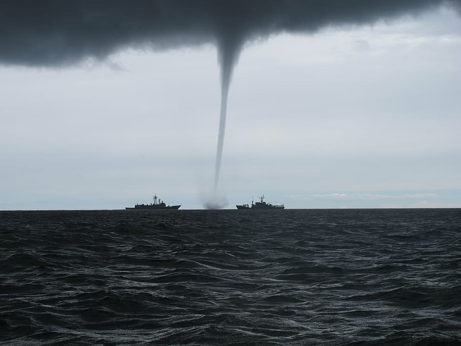 two black ship at sea near tornado, whirlwind, the baltic sea