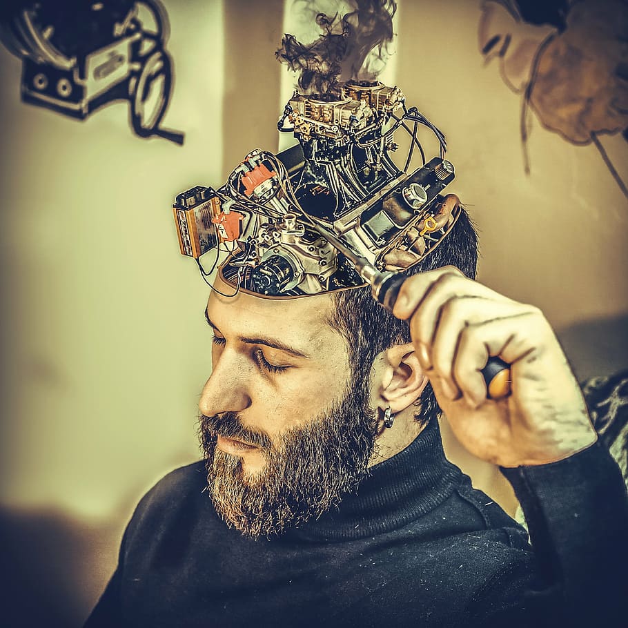 shallow focus photography of a man holding black metal device HD wallpaper