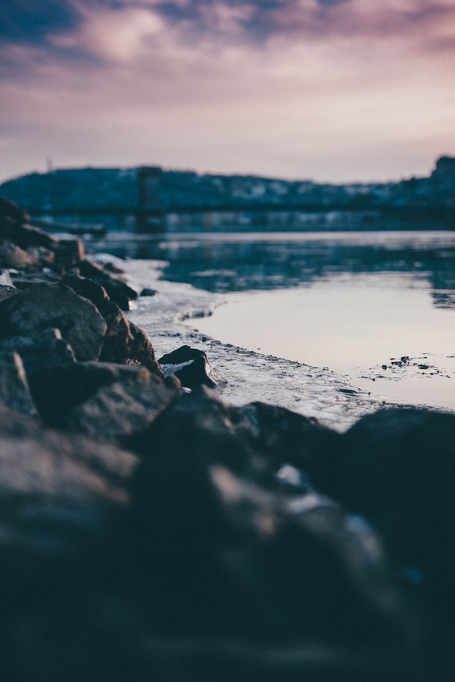 selective focus photography of rocks on shore during sunset HD wallpaper
