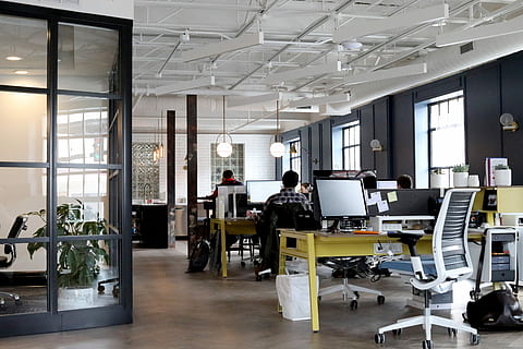 Old building, new office, flat screen computer monitor on yellow wooden table HD wallpaper