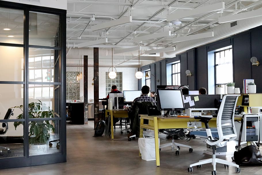 Old building, new office, flat screen computer monitor on yellow wooden table HD wallpaper