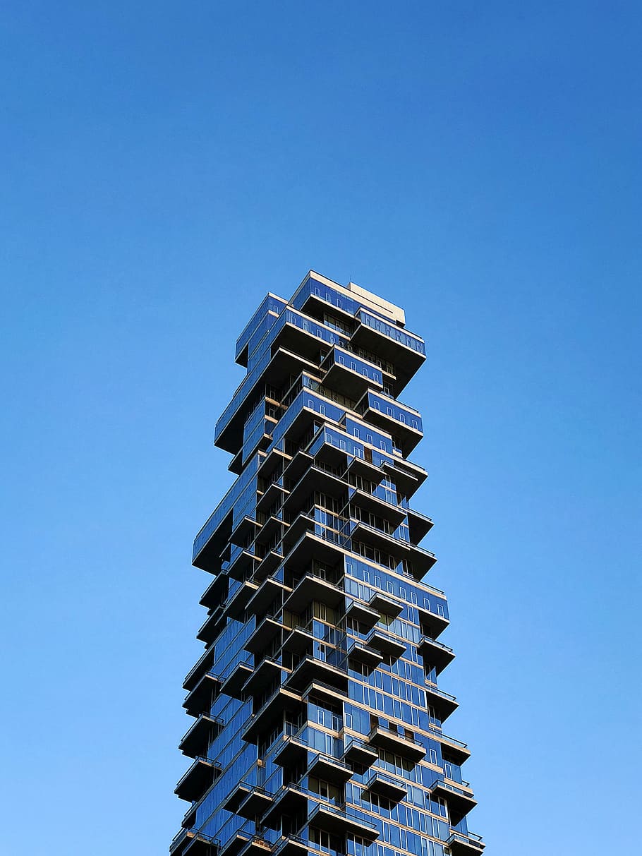 clear glass building under blue sky, blue building, high rise HD wallpaper
