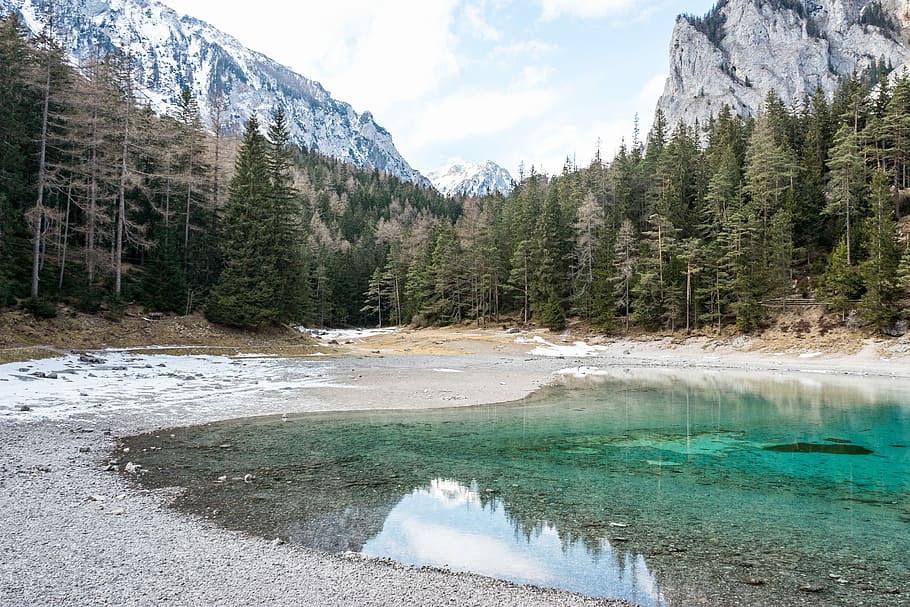 lake in the middle of green trees, mountain, snow, rock, cliff HD wallpaper