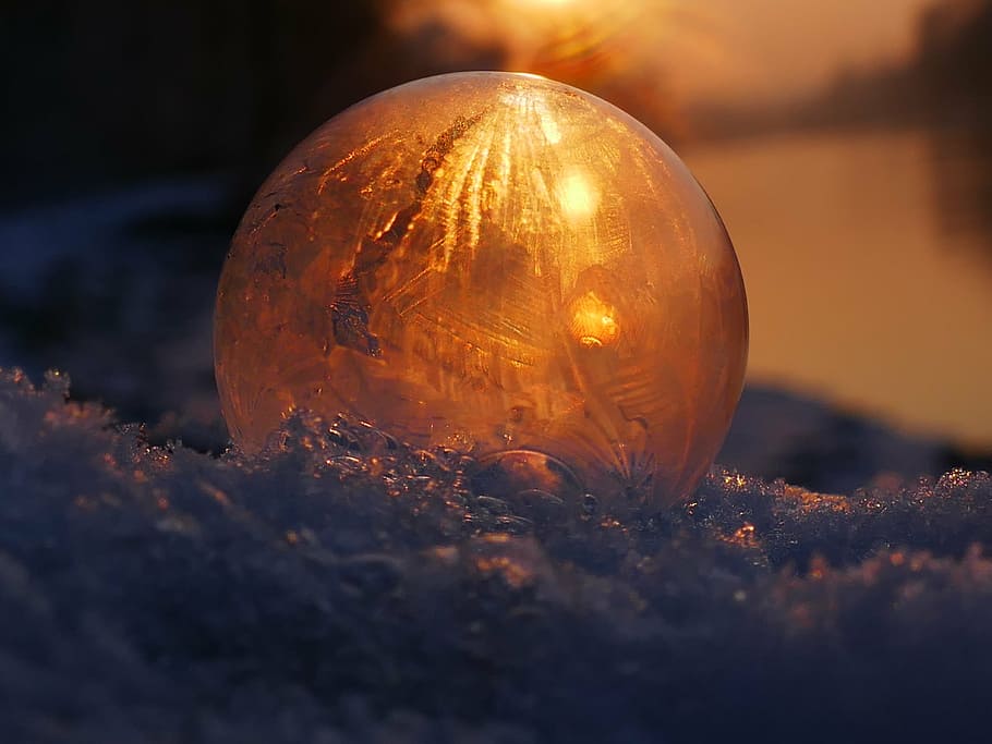 macro photo of round glass ball, soap bubble, frozen, frost, winter