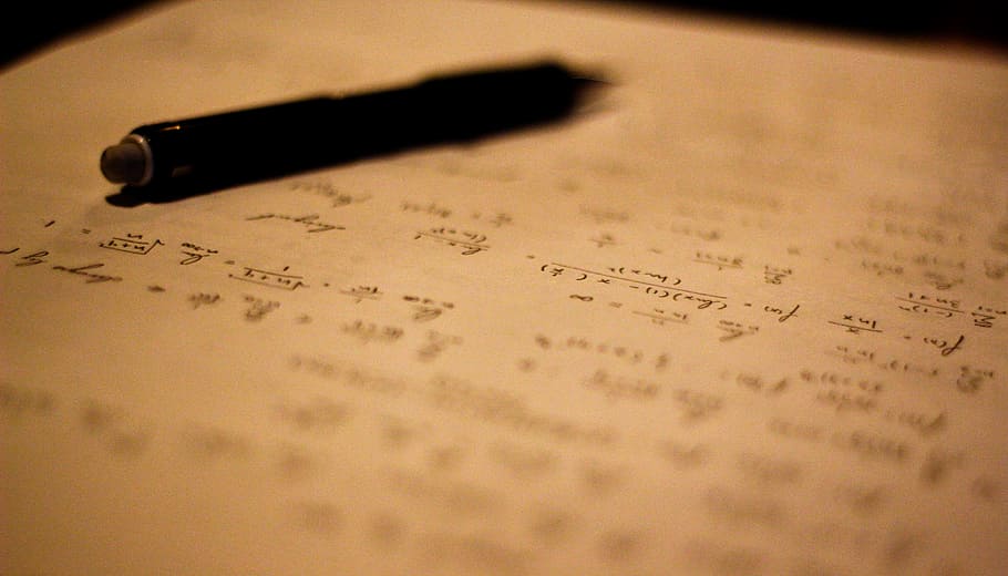 black click pen on white and black paper, writing, cursive, math