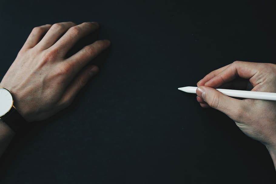 person wearing black analog watch holding white pencil, man holding Apple Pencil HD wallpaper