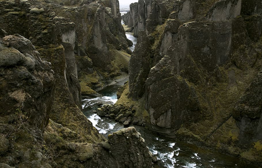 rocky terrain with river in middle, brown river during daytime HD wallpaper