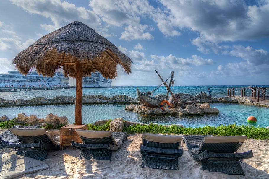 four black outdoor lounger chairs near body of water during daytime HD wallpaper